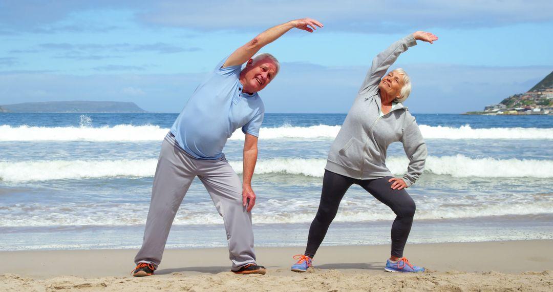 couple stretching on the beach